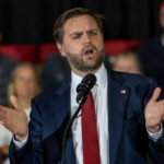 Rogers Pounces After Shock Admission Man in suit speaking at a podium