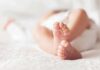 Custody Shock: Surrogate Ruled Not Mother baby feet on a soft white blanket