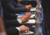 Energy Shake-Up: US-UK Bet Big on Fusion Hands of people in suits taking notes at a conference table
