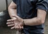 Judge Frees Suspect After Rabbi Beating person in handcuffs with hands behind back