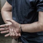 Judge Frees Suspect After Rabbi Beating person in handcuffs with hands behind back