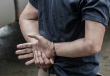 Judge Frees Suspect After Rabbi Beating person in handcuffs with hands behind back