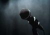 Microphone on a stand against a dark blurred background