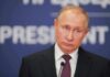 Glorious Gains? ISW Torpedoes Putin’s Victory Hype man in suit at podium with microphone