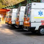 Row of ambulances parked outside a hospital entrance
