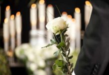 White rose held at a funeral