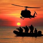 Intel-Driven Kill – Narco Boat Obliterated Helicopter hovers above armed team in inflatable boat at sunset