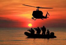 Intel-Driven Kill – Narco Boat Obliterated Helicopter hovers above armed team in inflatable boat at sunset