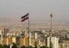 Iranian flag over Tehran skyline with Milad Tower