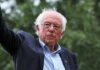 AI Freeze Threat – Bernie, Bannon Unite older man in suit and glasses outdoors