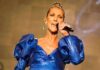 Singer performing in a blue metallic dress