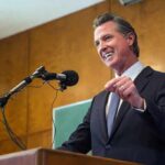 Newsom Torches Trump As EPA Reverses Course Gavin Newsom speaking at a podium with microphones
