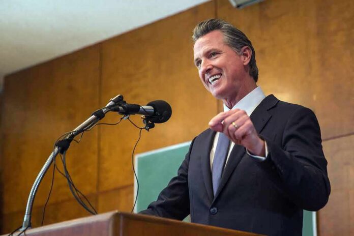 Gavin Newsom speaking at a podium with microphones