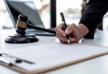 Botched Case, Buried Memo – Cover-Up or Chaos? Hand signing legal document beside gavel and laptop
