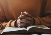 Christian Mom Triumphs – Oregon Backs Down Hands clasped over an open book