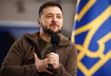 Patriot Deal Dangles – What’s Really Signed? man holding a microphone with hand on chest