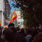 Spain Greenlights Extradition – Traps Millionaire In Hamas Cash Probe Crowd with Spanish flags in a city street