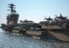 Aircraft carrier at sea with fighter jets on deck