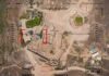Aerial view through drone HUD of archaeological ruins and surrounding campsite