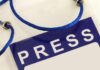 Press badge with blue lanyard