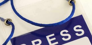 Press badge with blue lanyard