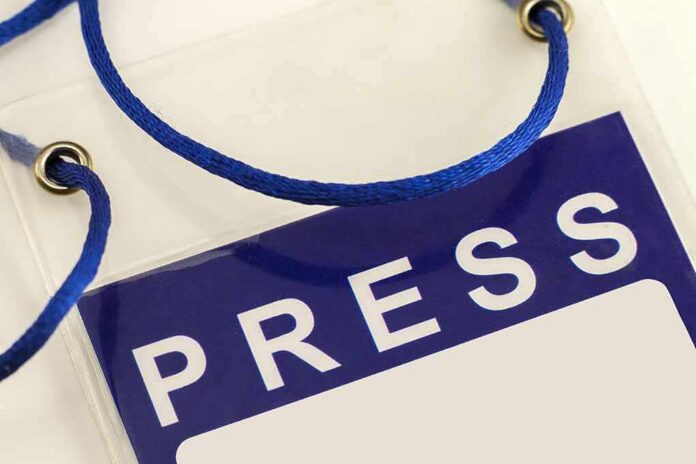 shutterstock_674926084-3 Press badge with blue lanyard