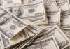 Yields Spike – 5% Line Breaks: Mortgages Next? Stacks of US $100 bills scattered