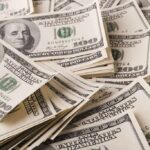 Stacks of US $100 bills scattered