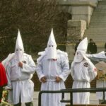 KKK Echo In Ad? Converse Apologizes ku klux klan members in white robes and hoods at a public gathering