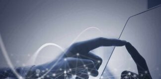 Hand touching a tablet screen with abstract network overlay