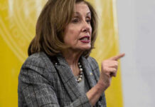 Nancy Pelosi speaking and gesturing with a pointed finger