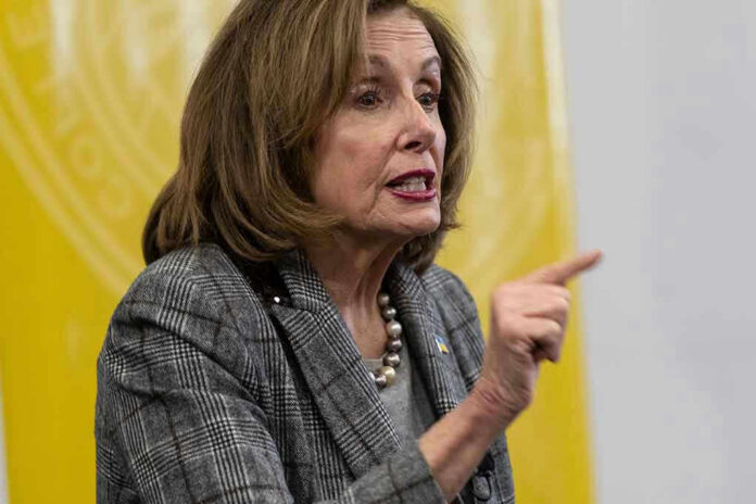 Nancy Pelosi speaking and gesturing with a pointed finger
