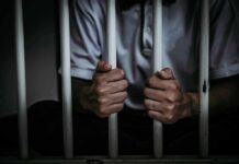 Compassionate Release Just Got Dangerous – Freedom Yanked Back? person gripping prison bars