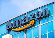 Army Deploys AI Defenders – AWS Tapped For War-Grade Cyber Muscle Amazon logo on glass office building facade