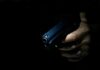 Hand holding a handgun in low light