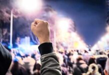 Oct. 7 Flashpoint Erupts At UCLA Raised fist in front of a large crowd at night