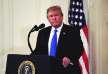 Fox Clash Erupts: Trump Torches Tarlov man at podium with microphone and US flag