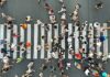 Crowd of pedestrians crossing a zebra crosswalk from above