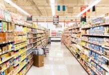 Tariff Whiplash – Prices Would’ve Fallen A grocery store aisle filled with various food products on shelves