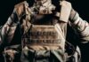 Soldier adjusting tactical plate carrier vest