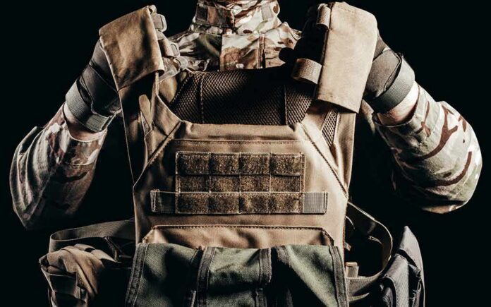 Soldier adjusting tactical plate carrier vest