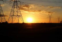 Transmission towers at sunset with power lines