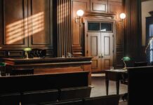 Brothers Busted in Hamas Fund Push Empty courtroom with wooden benches and judge's bench