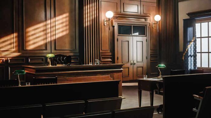 Empty courtroom with wooden benches and judge's bench