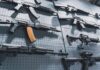 AK-47 Deal Turns – FBI Arrests Suspect Assault rifles displayed on a perforated wall
