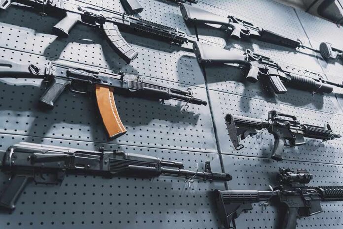 shutterstock_2164168123 Assault rifles displayed on a perforated wall
