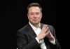 Hulk Star Sparks Musk Voting Panic Elon Musk seated in a black suit with hands clasped