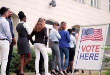 voters standing in line outside a polling place