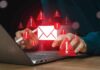person using laptop with email alert icons
