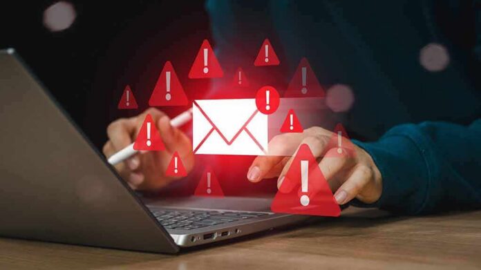 shutterstock_2461279109 person using laptop with email alert icons